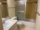 A clean bathroom with a combination shower and tub and a single sink at 1546 Grand Blvd # 108, Sarasota, FL 34232