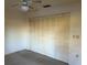 Clean bedroom with large closet, a fan, and multiple electrical outlets at 1546 Grand Blvd # 108, Sarasota, FL 34232