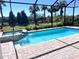 A pristine pool and spa combination is surrounded by brick and lush landscaping at 16446 Slate Pl, Bradenton, FL 34211