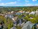 An aerial view of a neighborhood with houses, trees, and a view of the ocean in the background at 1746 Stapleton St, Sarasota, FL 34239