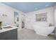 Modern bathroom with a soaking tub, marble shower, and gray vanity at 1746 Stapleton St, Sarasota, FL 34239