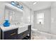 Elegant bathroom with marble countertops, a farmhouse sink, stylish lighting, and a pebble-stone shower floor at 1746 Stapleton St, Sarasota, FL 34239