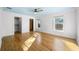 Bedroom with hardwood floors, large windows, and closet creating a warm and spacious atmosphere at 1746 Stapleton St, Sarasota, FL 34239