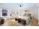 Stylishly staged bedroom featuring two benches, wood floors, and white furniture at 1746 Stapleton St, Sarasota, FL 34239