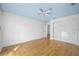 Open bedroom featuring sleek hardwood flooring, a ceiling fan, and a large sliding-door closet for ample storage at 1746 Stapleton St, Sarasota, FL 34239
