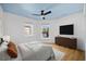 Bedroom featuring natural light from windows, with hardwood floors, ceiling fan, and entertainment center at 1746 Stapleton St, Sarasota, FL 34239