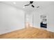 Bright bedroom boasts hardwood floors, ceiling fan, and ensuite bathroom access for a modern and airy feel at 1746 Stapleton St, Sarasota, FL 34239