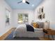 Comfortable bedroom featuring a plush bed, stylish decor, and natural light from the large windows at 1746 Stapleton St, Sarasota, FL 34239