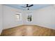 Bedroom with hardwood flooring, two windows with bright light, and a modern ceiling fan at 1746 Stapleton St, Sarasota, FL 34239