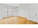 Bright, minimalist bedroom with hardwood floors, white walls, and natural light from the window at 1746 Stapleton St, Sarasota, FL 34239