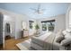Bright bedroom with hardwood floors, large windows, walk-in closet and a modern ceiling fan at 1746 Stapleton St, Sarasota, FL 34239