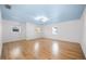 Large bonus room with natural light, hardwood floors, and ample space for entertaining and relaxation at 1746 Stapleton St, Sarasota, FL 34239