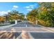 Grand entrance to a gated community with lush trees and landscaping at 1746 Stapleton St, Sarasota, FL 34239