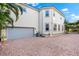 Exterior view of two-story home with a paver driveway and grey garage door at 1746 Stapleton St, Sarasota, FL 34239