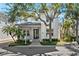 Charming two-story home featuring manicured landscaping, a welcoming porch, and a well-maintained front yard at 1746 Stapleton St, Sarasota, FL 34239