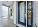 Inviting front porch featuring a modern door with glass panels and tiled flooring at 1746 Stapleton St, Sarasota, FL 34239