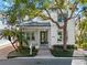 Charming two-story home featuring a welcoming porch, lush landscaping, and a classic architectural style at 1746 Stapleton St, Sarasota, FL 34239
