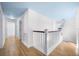 Bright hallway with hardwood floors, white railings, and a cozy atmosphere connecting different areas of the home at 1746 Stapleton St, Sarasota, FL 34239