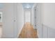 Clean hallway with hardwood flooring, light walls and white trim for a bright, airy feel at 1746 Stapleton St, Sarasota, FL 34239