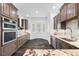 Eat-in kitchen with stainless steel appliances, custom cabinets, granite countertops, and bay window at 1746 Stapleton St, Sarasota, FL 34239
