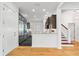 Open-concept kitchen boasts stainless steel appliances, dark wood cabinets, granite countertops, and hardwood floors at 1746 Stapleton St, Sarasota, FL 34239