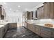 Spacious kitchen with stainless steel appliances, dark wood cabinets, granite countertops, and under cabinet lighting at 1746 Stapleton St, Sarasota, FL 34239