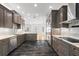Modern kitchen featuring stainless steel appliances, dark wood cabinets, granite countertops, and stylish lighting at 1746 Stapleton St, Sarasota, FL 34239