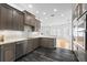 Gourmet kitchen featuring stainless steel appliances, custom cabinets, granite countertops, and a breakfast bar at 1746 Stapleton St, Sarasota, FL 34239