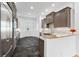 Well-equipped kitchen featuring stainless steel appliances, dark wood cabinets, granite countertops, and modern fixtures at 1746 Stapleton St, Sarasota, FL 34239