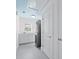 Laundry room with white cabinets, counter space, a window, and a stacked washer and dryer at 1746 Stapleton St, Sarasota, FL 34239