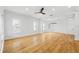 Bright, open living room with hardwood floors, large windows, and modern ceiling fan at 1746 Stapleton St, Sarasota, FL 34239