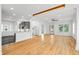 Spacious open-concept living area with hardwood floors, modern lighting, and seamless kitchen access at 1746 Stapleton St, Sarasota, FL 34239