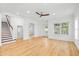 Open living area with hardwood floors, staircase, and views to the front of the home at 1746 Stapleton St, Sarasota, FL 34239