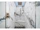 Beautiful shower with luxurious finishes including marble tiling and accent hardware at 1746 Stapleton St, Sarasota, FL 34239