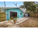 Backyard patio with sliding glass doors and a convenient storage shed for outdoor needs at 3200 Tobero Ln, Sarasota, FL 34235