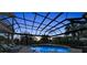 Luxurious swimming pool and spa area with sun loungers, all enclosed within a screened lanai at 3360 Founders Club Dr, Sarasota, FL 34240