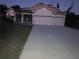 Exterior view of the house with a large driveway and a two-car garage at 4432 Collingswood Blvd, Port Charlotte, FL 33948