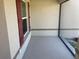 This outdoor patio features a window with red shutters on textured walls at 4432 Collingswood Blvd, Port Charlotte, FL 33948