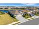 Aerial view of home showing a lake view, three-car garage, and meticulous landscaping at 5035 Seafoam Trl, Bradenton, FL 34211