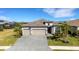 A beautiful home with a 3-car garage, manicured lawn, and welcoming curb appeal at 5035 Seafoam Trl, Bradenton, FL 34211