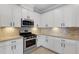 Stylish kitchen showcasing white cabinets, modern hardware, and stainless steel appliances at 5035 Seafoam Trl, Bradenton, FL 34211