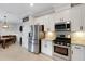 Bright kitchen with stainless steel appliances, white cabinetry, and modern countertops at 5035 Seafoam Trl, Bradenton, FL 34211