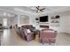Cozy living room featuring a modern fireplace, tile floors, and coffered ceilings at 5035 Seafoam Trl, Bradenton, FL 34211