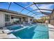 Covered pool features a jacuzzi and lounge chairs, perfect for enjoying the outdoors year-round at 5035 Seafoam Trl, Bradenton, FL 34211