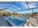 Beautiful screened-in pool and hot tub with sun shelf, overlooking a serene lake at 5035 Seafoam Trl, Bradenton, FL 34211