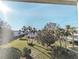 Scenic view from the balcony overlooking lush green landscaping and mature palm trees under a bright blue sky at 5918 Palm Ln # C33, Bradenton, FL 34207