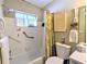 Bathroom featuring a shower-tub combo and a storage shelf at 5918 Palm Ln # C33, Bradenton, FL 34207
