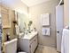 Bright bathroom featuring a vanity with storage and framed mirror at 5918 Palm Ln # C33, Bradenton, FL 34207