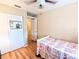 Cozy bedroom featuring hardwood floors, a ceiling fan and closet space at 5918 Palm Ln # C33, Bradenton, FL 34207