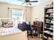 Well-lit bedroom featuring a dark wood desk and bookcase at 5918 Palm Ln # C33, Bradenton, FL 34207